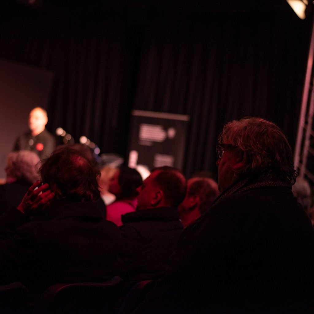 An audience watching the Beyond the Pier preview show in a darkened venue