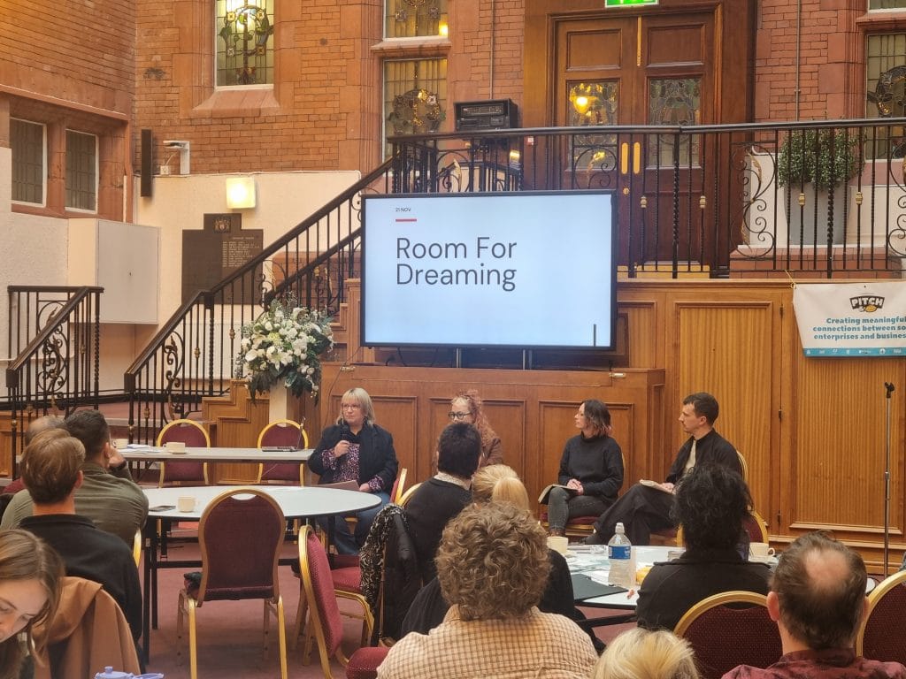 A 'Room for Dreaming' panel discussion at Social Enterprise Day, with guests seated at round tables