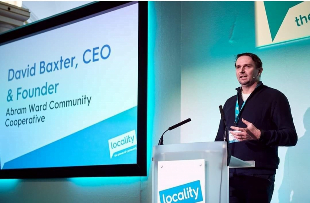 David Baxter, CEO and founder of Abram Ward Community Cooperative, speaking at a Locality conference lectern