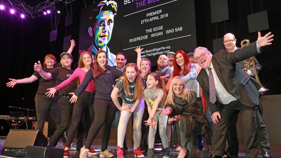 The cast of Beyond the Pier on stage at the musical's premiere at The Edge in Wigan